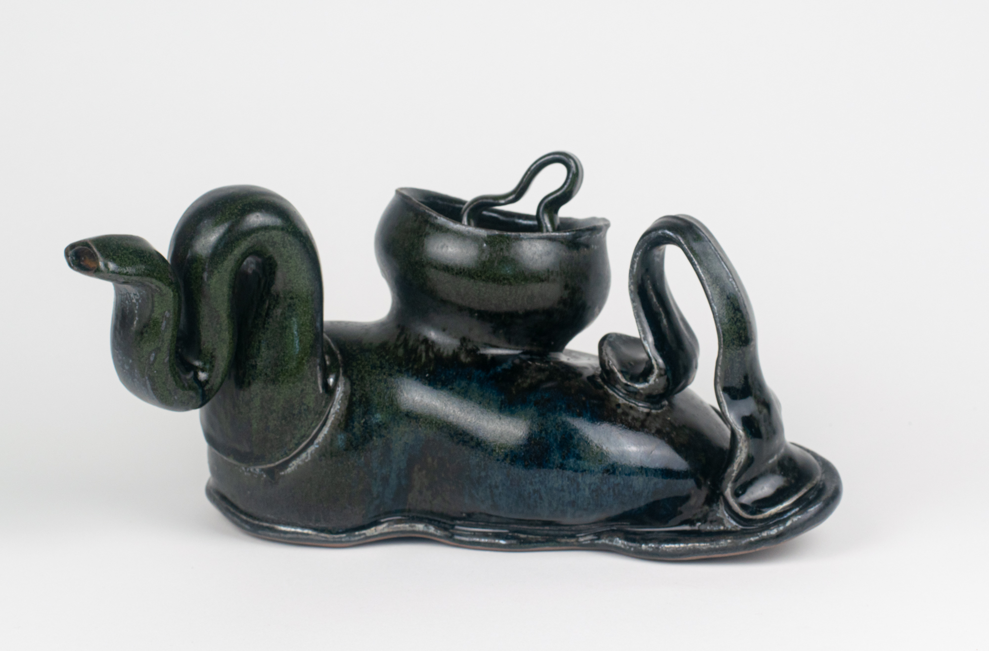 Dark glazed ceramic vessel with curved spout and handle